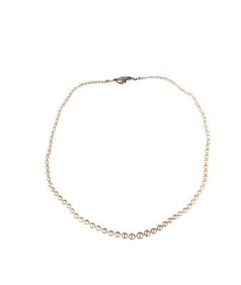 a pearl and diamond necklace on a white background