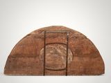 an old wooden object with a hole in the middle of it
