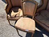 three chairs and a chair with a footstop are sitting outside