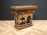 a small wooden table with a shelf on top of it