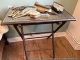 a small table with brushes, combs, and a mirror on it