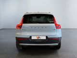 the rear end of a silver volvo v - pace parked in a white room