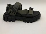 a close up of a pair of black sandals on a white surface