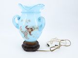 a blue vase that is sitting on a wooden stand