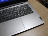 a laptop computer sitting on top of a wooden table