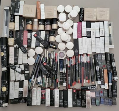 a lot of makeup and cosmetics products laid out on a table