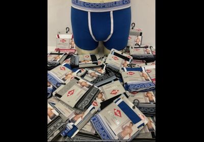 a pile of money sitting on top of a pile of underwear