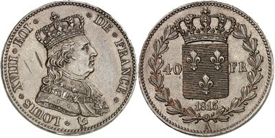 a silver coin with a crown on top of it