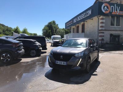 a car parked in front of a building with cars parked in front of it
