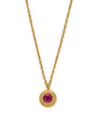 a gold necklace with a ruby stone on a chain