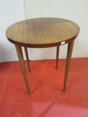a small table with a wooden top on a red floor