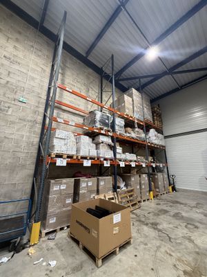 un grand entrepôt rempli de boîtes et de palettes
