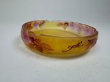 a yellow bowl with flowers on it sitting on a table