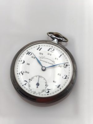 a close up of a pocket watch on a white surface