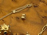 a wooden table with a bunch of jewelry on it