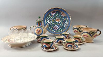 many pieces of pottery sitting on the table together