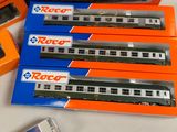 several boxes of toy trains sitting on top of a white table