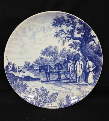 a blue and white plate with a picture of a horse drawn carriage