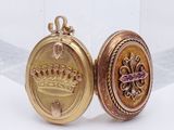 two gold lockes with a crown on the front and a crown on the back