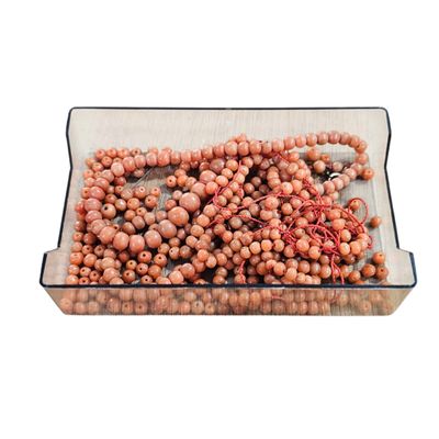 a glass tray with a bunch of beads on it