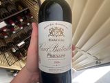 a person holding a bottle of wine in their hand