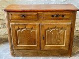 a wooden cabinet with two drawers and a door
