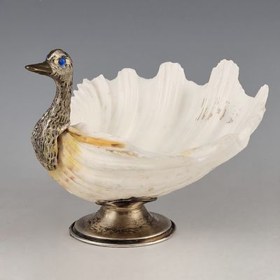 a white bowl with a duck on top of it