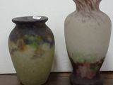 two vases that are sitting on a wooden table