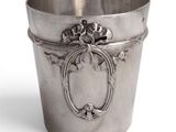 a silver cup with a flower decoration on it