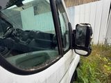 a white van that is parked next to a building