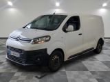 the white van is parked in a large room with a checkered floor