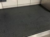 an image of a kitchen with a black counter top