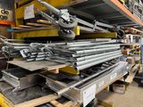 a large pile of steel pipes in a warehouse