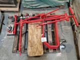 a picture of a red pipe clamp on a pallet