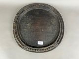 a silver plate with a decorative design on it