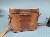 a small brown bag with a camera attached to it