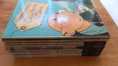 a stack of books on a table with a picture of a man