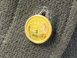 a picture of a gold coin on a gray sweater
