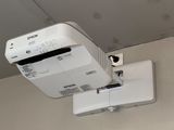 a projector mounted to the ceiling in a room