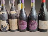 several bottles of wine are lined up in a row on a table