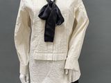 an image of a mannequin dressed in a white shirt and black tie