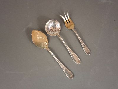 three spoons and a fork on a table