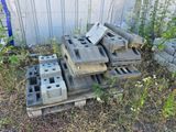a pile of cinder blocks on a pallet in the yard