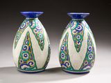 pair of blue and white vases sitting on top of a white table