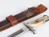 a knife and sheath on a white surface
