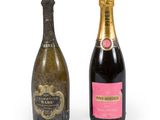 two bottles of champagne sitting next to each other on a white surface