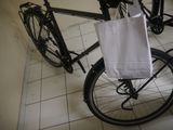 a bike that has a bag on the back of it
