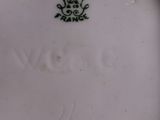 a close up of a plate with a frog on it