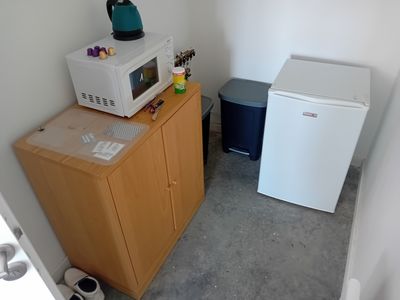 a microwave and a refrigerator in a small room