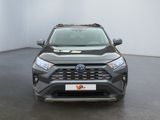 the front of a grey toyota rav parked in a white room